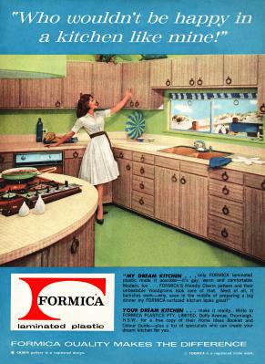 A 1963 advert for a Formica woodgrain finish laminated plastic fitted kitchen. It appeared in an Australian magazine. The photograph shows a 'happy' housewife showing off her new 'dream' kitchen
